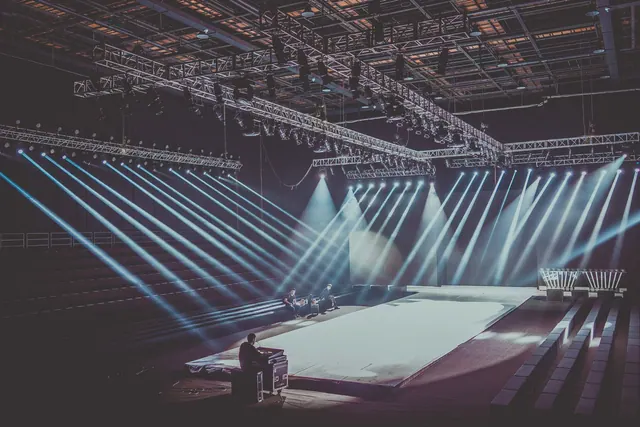 An expansive indoor stage with dramatic lighting setup, ready for a performance or event. Competitive intelligence: a practical guide for 2027