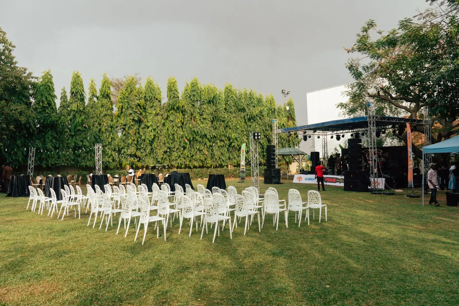 An outdoor event venue with white chairs, stage setup, sound equipment, and greenery surrounding the space. Product marketing analytics: a practical guide for 2027