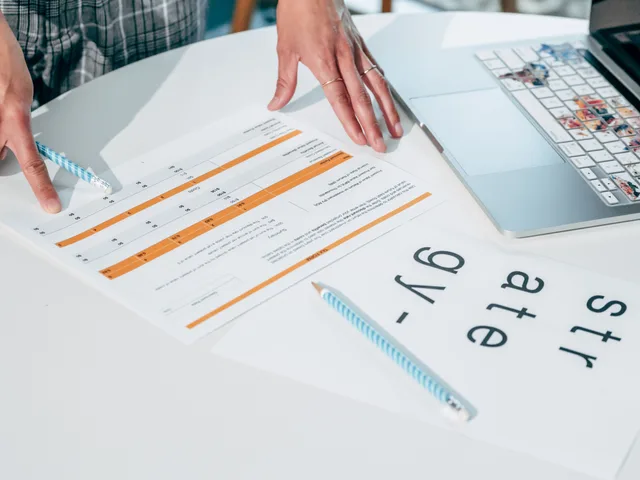 Close-up of hands reviewing business documents and strategy papers on an office desk. Product messaging tools, sorted out: the 2027 view