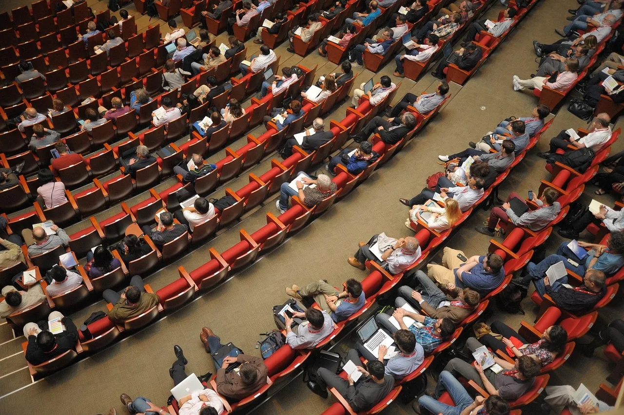 event venue, auditorium, meeting, forum, conference, listener, audience, public, people, sit, watching. Sales enablement trends for product launch positioning