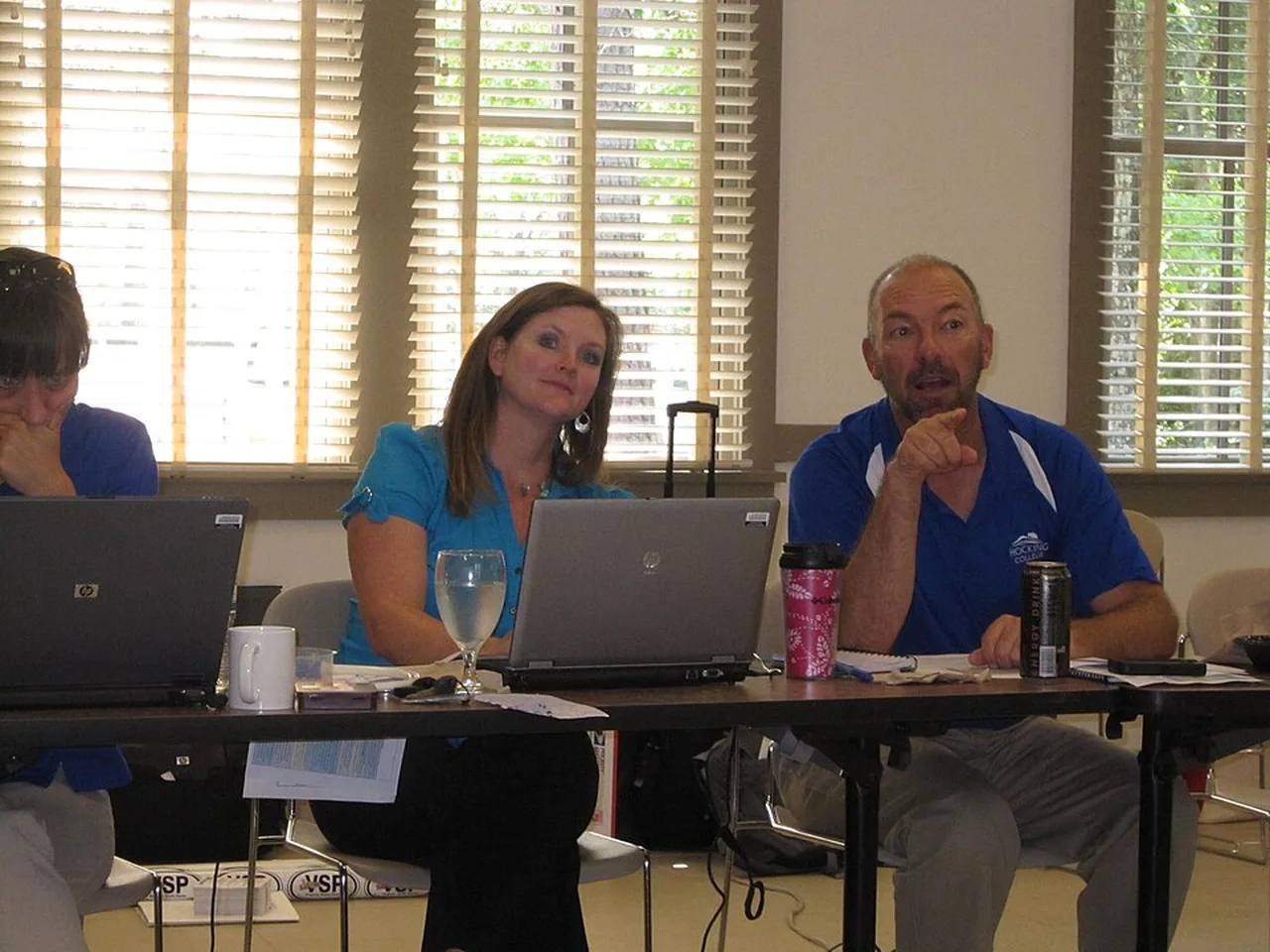 Members of a marketing team sit around a table during a meeting.